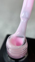 The UV Color Base Pink by Alisa Nails, made in Germany, is a high-quality base coat that combines color and protection in one product. Its soft pink hue provides a natural, elegant look, while ensuring long-lasting adhesion for UV gel or polish. The self-leveling formula allows for easy application and cures quickly under UV or LED light. Perfect for all nail types, this base coat strengthens the natural nail and prevents discoloration, offering both beauty and durability in your manicure.